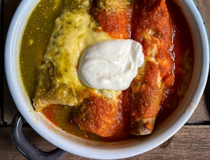 Plato de enchiladas con complementos en un negocio de enchiladas.