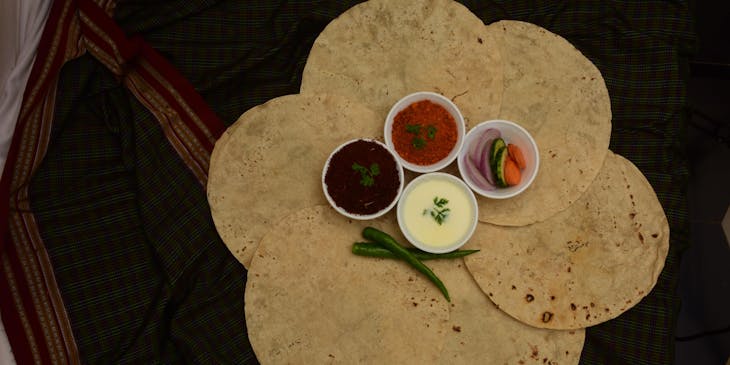 Seis tortillas extendidas con aderezos al centro listas para utilizarse en un negocio de tlayudas.