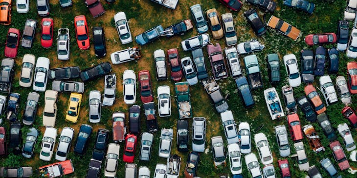 Vista aérea de decenas de vehículos inservibles estacionados en un yonke.