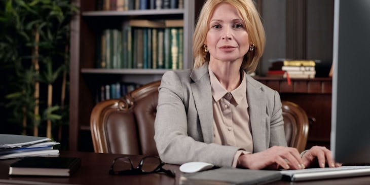 A notary sitting in front of her computer in a legal office.
