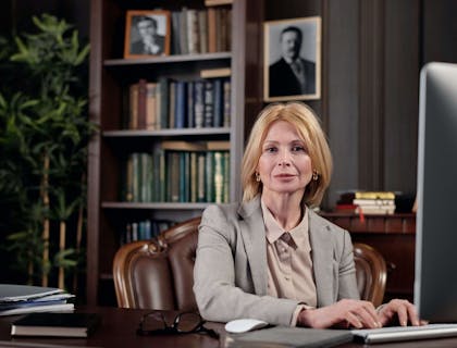 A notary sitting in front of her computer in a legal office.