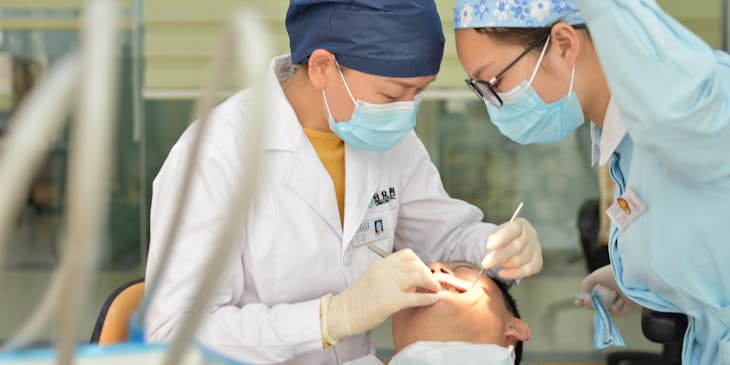 Oral surgeon performing a dental assessment.