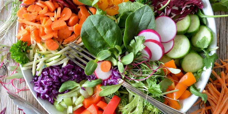 A bowl of vegetables displayed on a table at an organic food business.