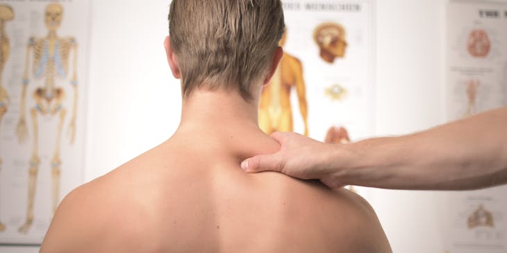 Orthopedist checking woman's joints.