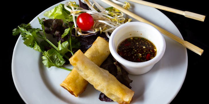 Plate with spring rolls and chop sticks at a Pan-Asian restaurant
