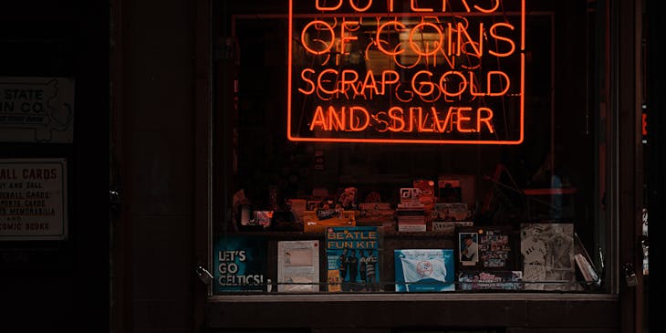 Pawnshop window display with neon signage.