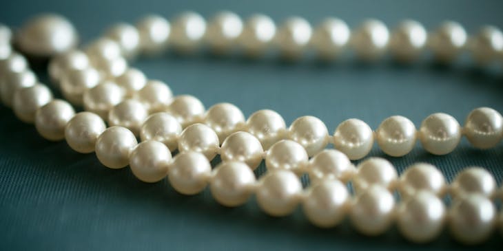 A string of pearls on a blue background.