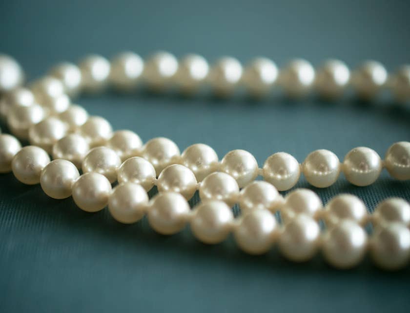 A string of pearls on a blue background.