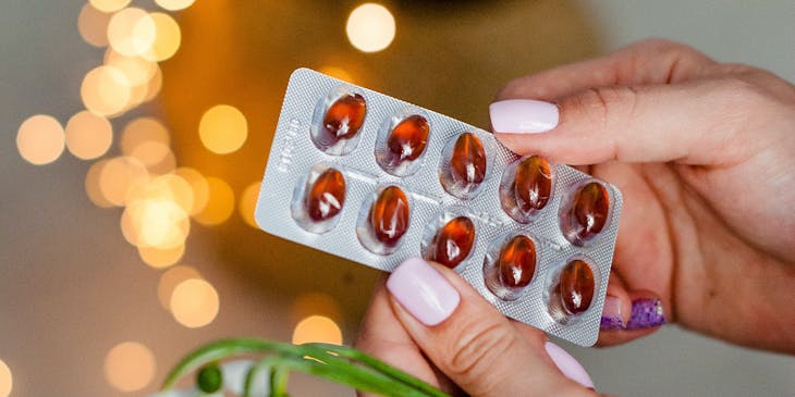 A patient holding homeopathic pills at a placenta encapsulation business.
