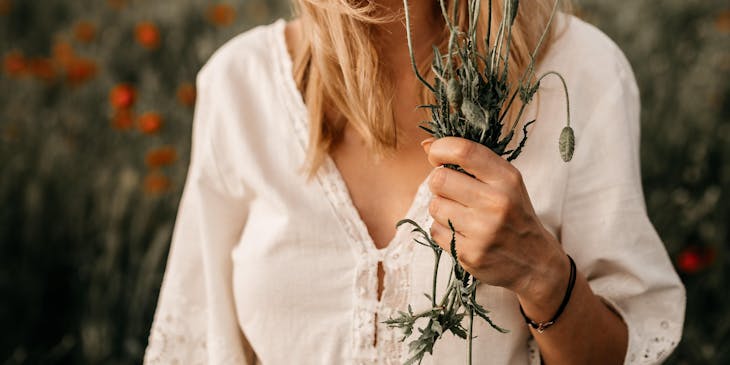 A woman having a pleasant time picking flowers.
