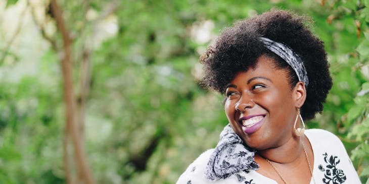 A plus-size fashion model smiling.