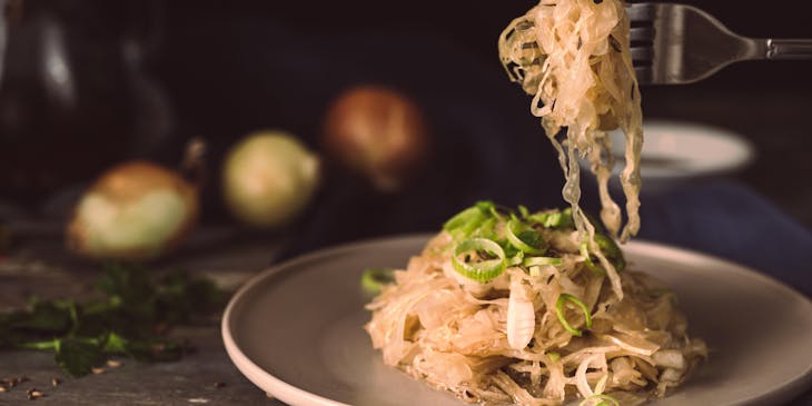 A Polish restaurant serving pasta with sauerkraut on a ceramic plate.