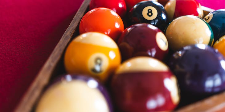Pool balls on a pool table.