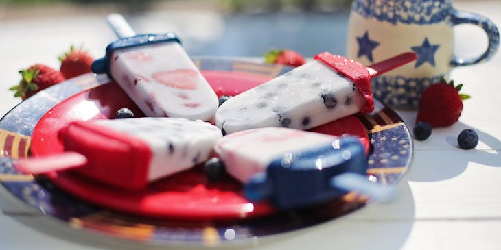 Popsicles on a red plate.