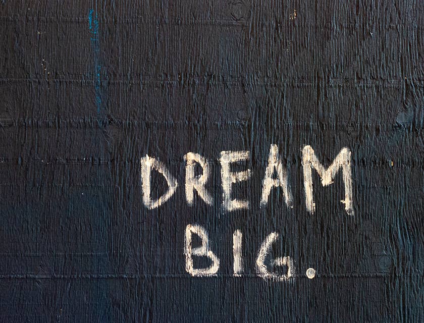 A sign with a positive message that reads "dream big".