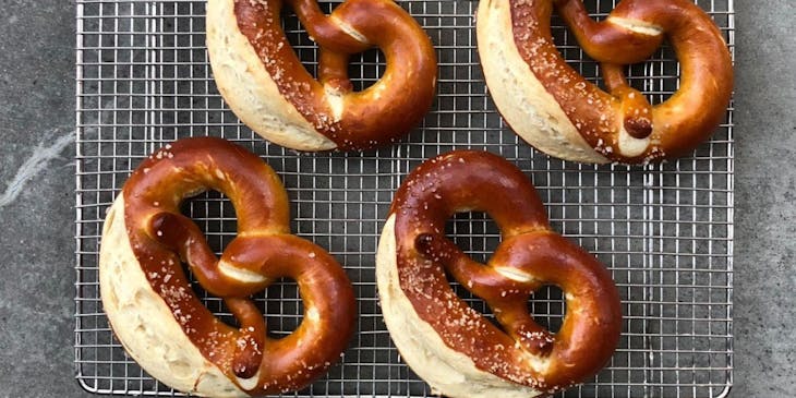 A delicious rack of pretzels about to be served in a pretzel shop.