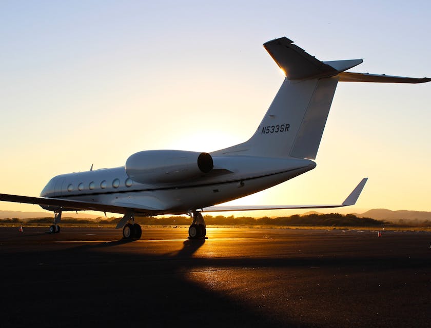 A private jet on a landing strip at an airport.