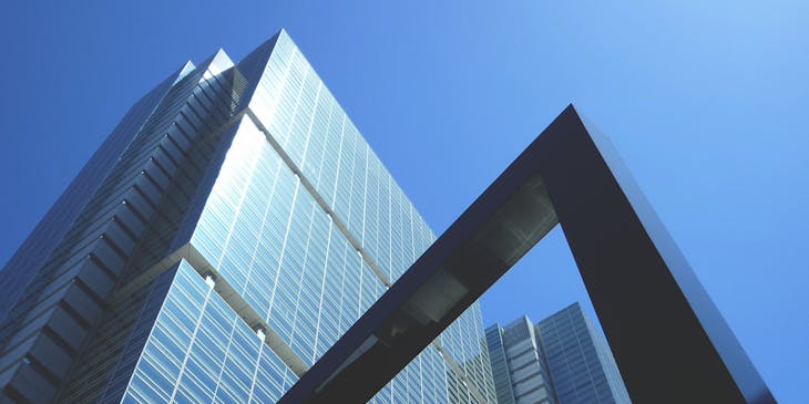 An upmarket office building rising above the street.