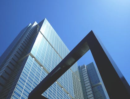 An upmarket office building rising above the street.