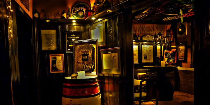 A beautifully decorated wooden pub interior with posters on display.