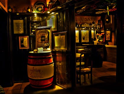 A beautifully decorated wooden pub interior with posters on display.