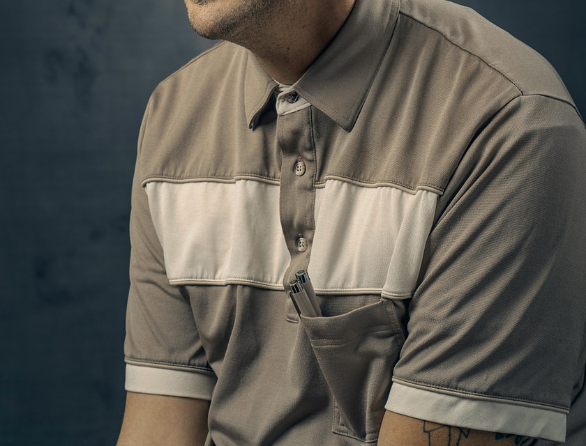 Man posing in a gray shirt.