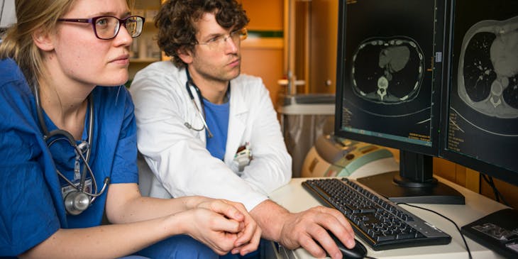 Radiologists examine a scan.
