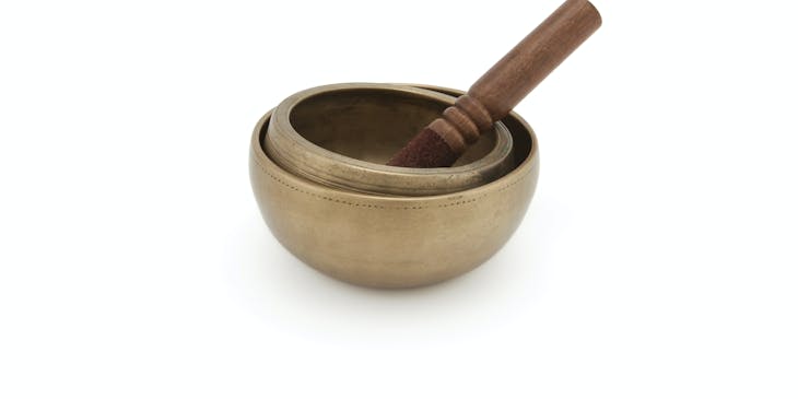 Reiki healing bowls on white table.