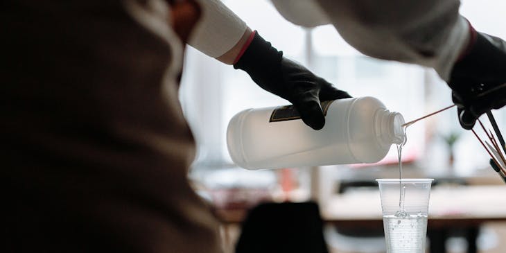 A person pouring resin into a cup.