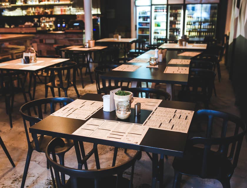 Un restaurant vide avec des sets de table sur les tables.