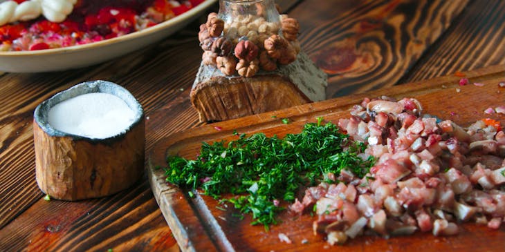 Herring under a fur coat served on wooden dishes at a Russian restaurant.