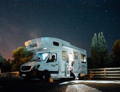 A family in an RV under the stars.