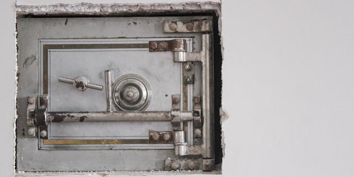 A closed safe in a wall.