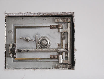 A closed safe in a wall.