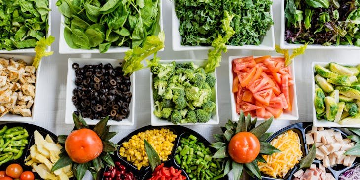 Assorted salad ingredients on display at a salad bar.
