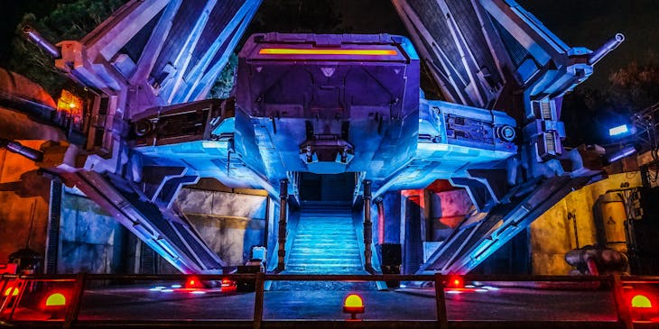 A spaceship with dramatic lights against a dark background.