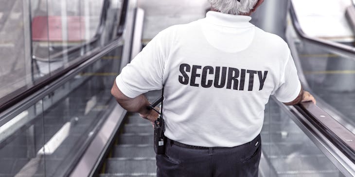 Security guard standing in the lobby of corporate offices.