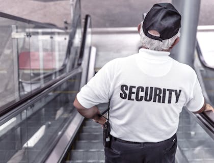 Security guard standing in the lobby of corporate offices.