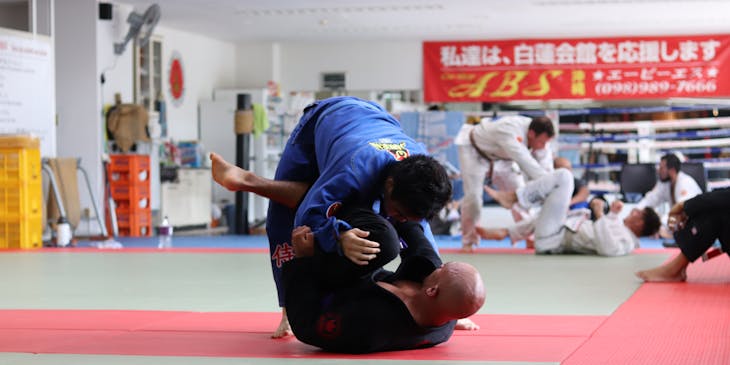 A man teaching martial arts at a self-defense class business.