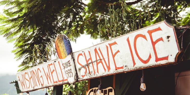 Shaved ice stand in a sunny outdoor area.