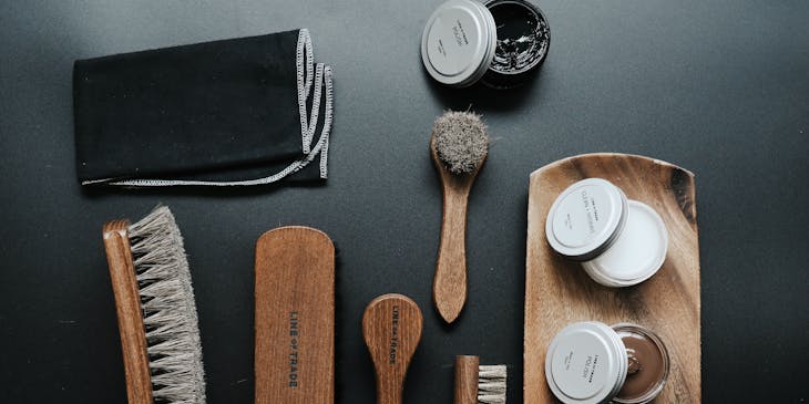 Assorted brushes and shoe cleaning business products.
