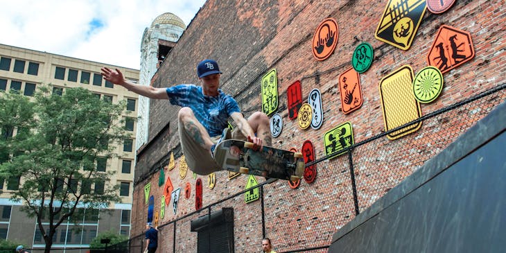 A skateboarder at a skate park doing tricks.