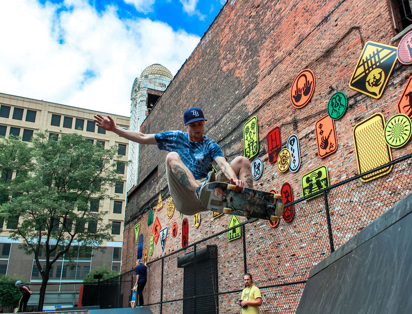 A skateboarder at a skate park doing tricks.