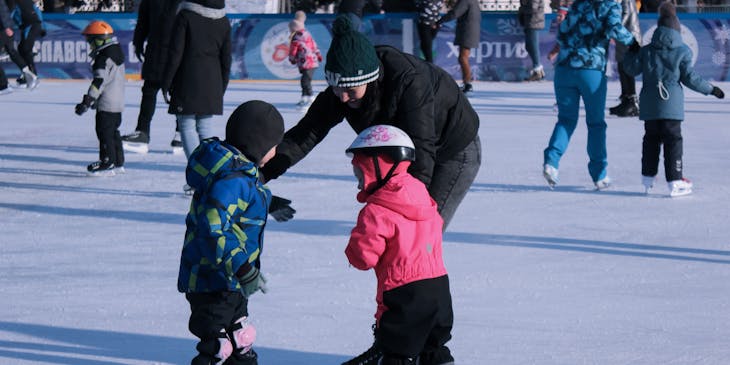 Children skating on an ice rink.