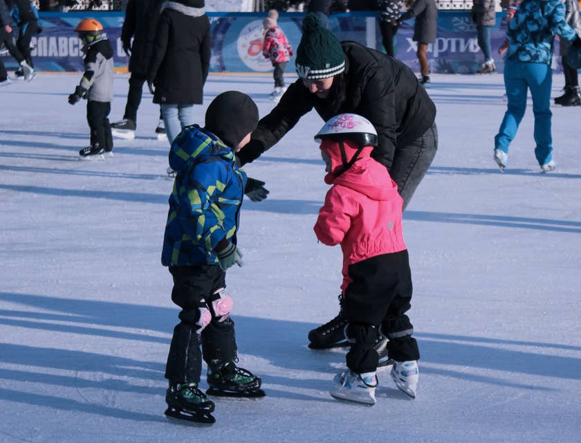 Children skating on an ice rink.
