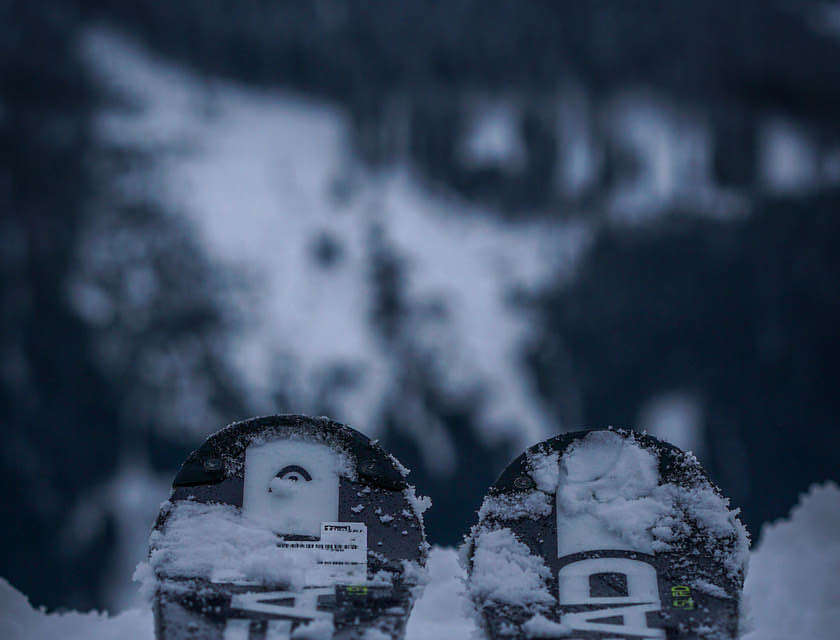Une paire de ski placés sur une pente enneigée.