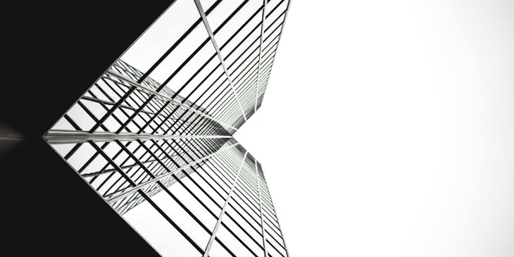 A sleek and modern building viewed from below.