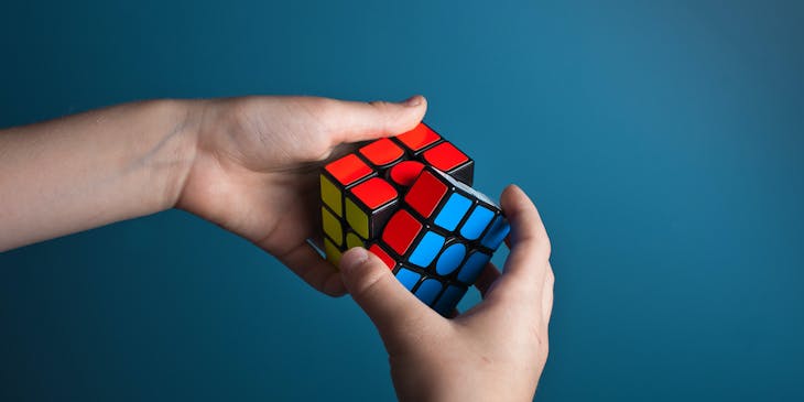A smart man solving a Rubik's cube.
