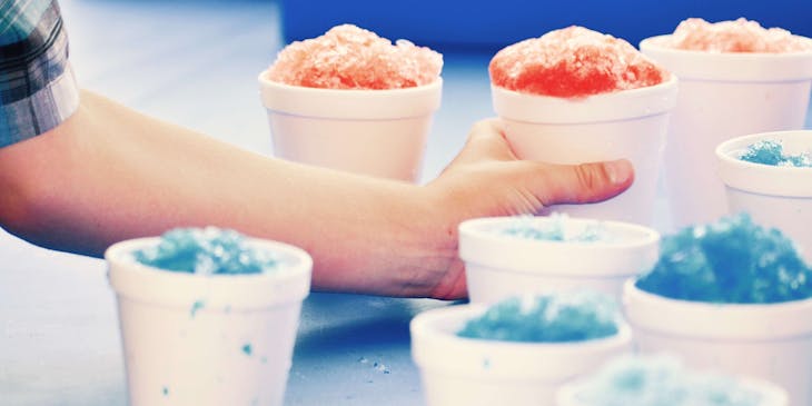 Snow cones in white cups.
