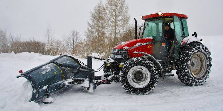 Snow plow truck cleaning snow